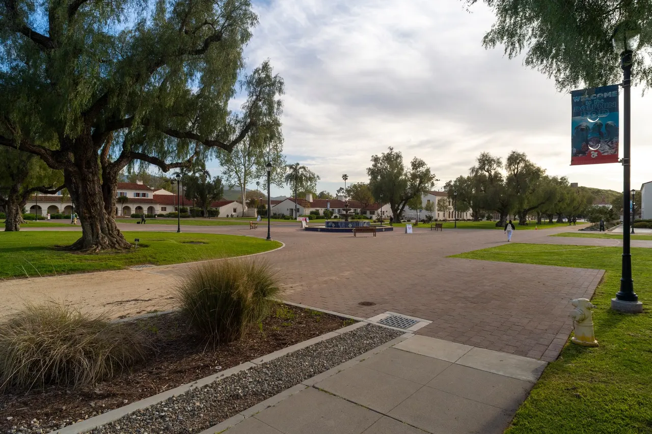 The central mall at CSU Channel Islands, with a pepper tree and Spanish-style buildings