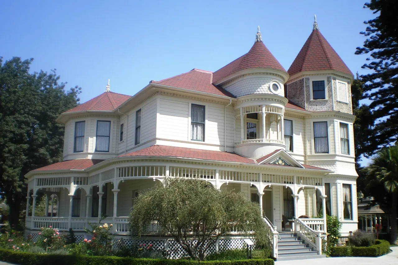 The Camarillo Ranch House, a white Victorian house with red roofs and a wraparound porch